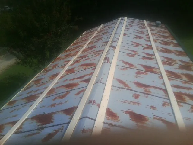 Rusted metal roof panels with new wood purlins before replacement — Storm Damage Roof Repair in Yreka by Roofing Brothers